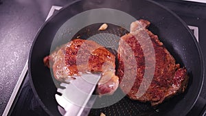 cooking meat in a frying pan. Young veal steak is a tender cut of meat
