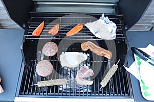 Cooking meat outdoors on a gas flamed bbq