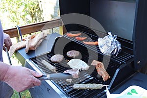 Cooking meat outdoors on a gas flamed bbq