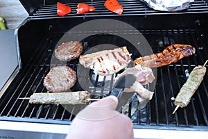 Cooking meat outdoors on a gas flamed bbq