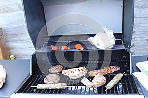 Cooking meat outdoors on a gas flamed bbq