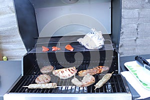 Cooking meat outdoors on a gas flamed bbq