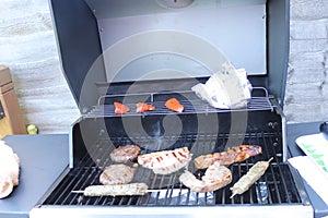 Cooking meat outdoors on a gas flamed bbq