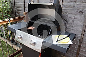 Cooking meat outdoors on a gas flamed bbq photo