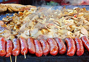 Cooking Meat, Vegetables and Sausages on a Griddle