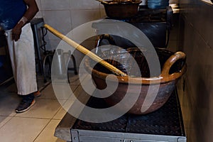 Cooking Mexican Mole food in a traditional clay pot in Mexico