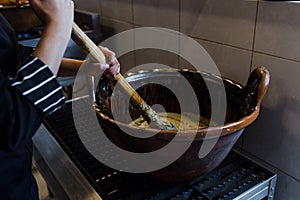 Cooking Mexican Mole food in a traditional clay pot in Mexico