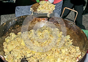 Cooking migas or Crumbs a typical spanish food. Crumbs prepared in a frying pan