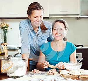 Cooking mother with adult daughter