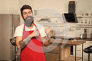 Cooking is my life. Bearded man in red apron. Restaurant or cafe cook. Hipster in kitchen. Mature male. Bearded man cook