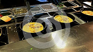 Cooking omelettes and fried eggs. Breakfast buffet in restaurant