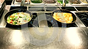 Cooking omelettes and fried eggs. Breakfast buffet in restaurant in hotel