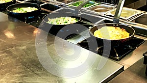 Cooking omelettes and fried eggs. Breakfast buffet in restaurant in hotel