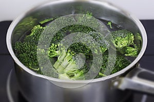 Cooking organic broccoli in stainless steel pan