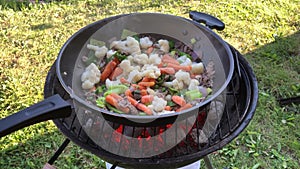 Cooking outdoors on a wok