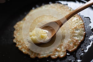 Cooking pancakes in a hot pan with butter