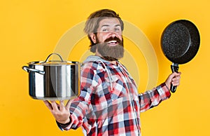 Cooking with passion. professional cook. bearded man hold kitchen pan. brutal hipster cooking with saucepan. housekeep