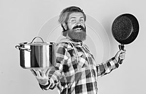 Cooking with passion. professional cook. bearded man hold kitchen pan. brutal hipster cooking with saucepan. housekeep