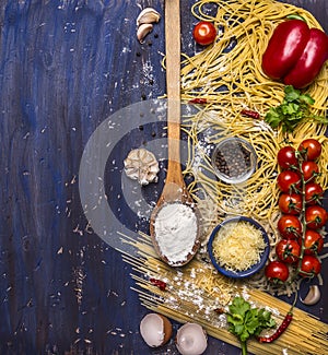 Cooking pasta concept with tomatoes, parmesan cheese, pepper, spices, flour, garlic, wooden spoon, border, text area on blue