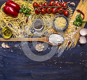 Cooking pasta concept with tomatoes, parmesan cheese, pepper, spices, flour, garlic, wooden spoon, border, with text area on blue