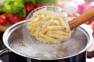 Cooking pasta in a pot with boiling water