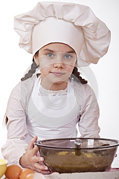 Cooking and people concept - smiling little girl in cook hat