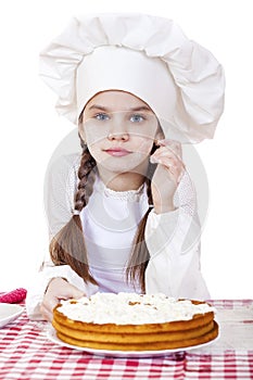 Cooking and people concept - smiling little girl in cook hat