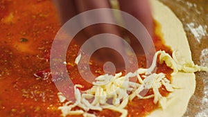 Cooking pizza. A man or woman is engaged in home business preparing a delicious pizza