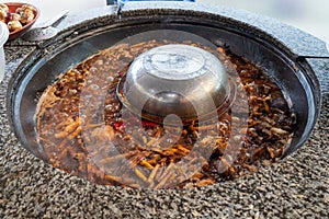 Cooking of plov in the Kazan cauldron at the Central Asian Plov Centre, Tashkent, Uzbekistan