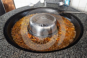 Cooking of plov in the Kazan cauldron at the Central Asian Plov Centre, Tashkent, Uzbekistan