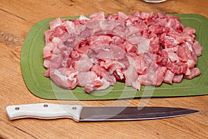 Cooking pork meat. Sliced meat on a cutting board. Ingredient for cooking