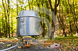 Cooking on a portable gas burner in outdoor conditions hikes