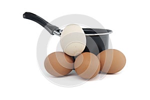 Cooking pot surrounding eggs isolated on white background