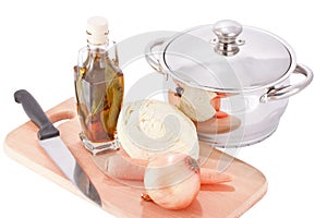 Cooking pot and vegetables on chopping board