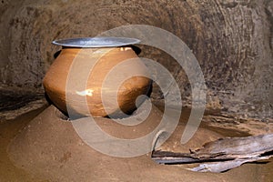 Cooking pot on a wood fired clay oven at rural village In India