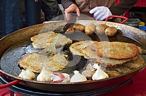 Cooking potato pancakes in the street of Cesky Krumlov