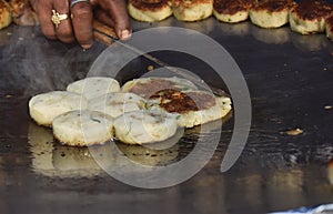 Cooking potato patty on pan