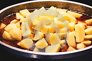 Cooking potato roast in tomato broth