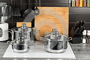 Cooking pots in kitchen on white induction hob photo
