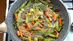 Cooking process, healthy food, vegetarian cuisine. Vegetables frying on a pan