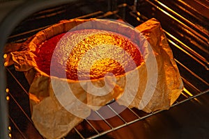 Cooking process homemade Basque burnt cheesecake. Ready toasted cheesecake is in the oven. Recipe step by step
