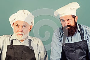 Cooking process. serious men in cook hat. mature bearded chef. tired of cooking. masters of kitchen. who is the best
