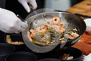 cooking process of Suquet de Peix soup with potatoes, herbs and fish with the addition of picada close-up in a saucepan