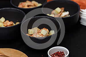 cooking process of Suquet de Peix soup with potatoes, herbs and fish with the addition of picada close-up in a saucepan