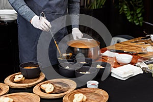 cooking process of Suquet de Peix soup with potatoes, herbs and fish with the addition of picada close-up in a saucepan