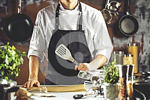 Cooking, profession and people concept - male chef cook making food at restaurant kitchen