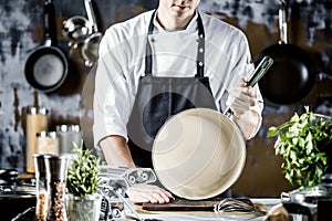 Cooking, profession and people concept - male chef cook making food at restaurant kitchen