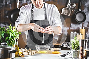 Cooking, profession and people concept - male chef cook making food at restaurant kitchen