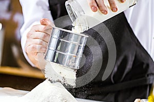 Cooking, profession and people concept - male chef cook making food at restaurant kitchen