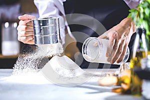 Cooking, profession and people concept - male chef cook making food at restaurant kitchen